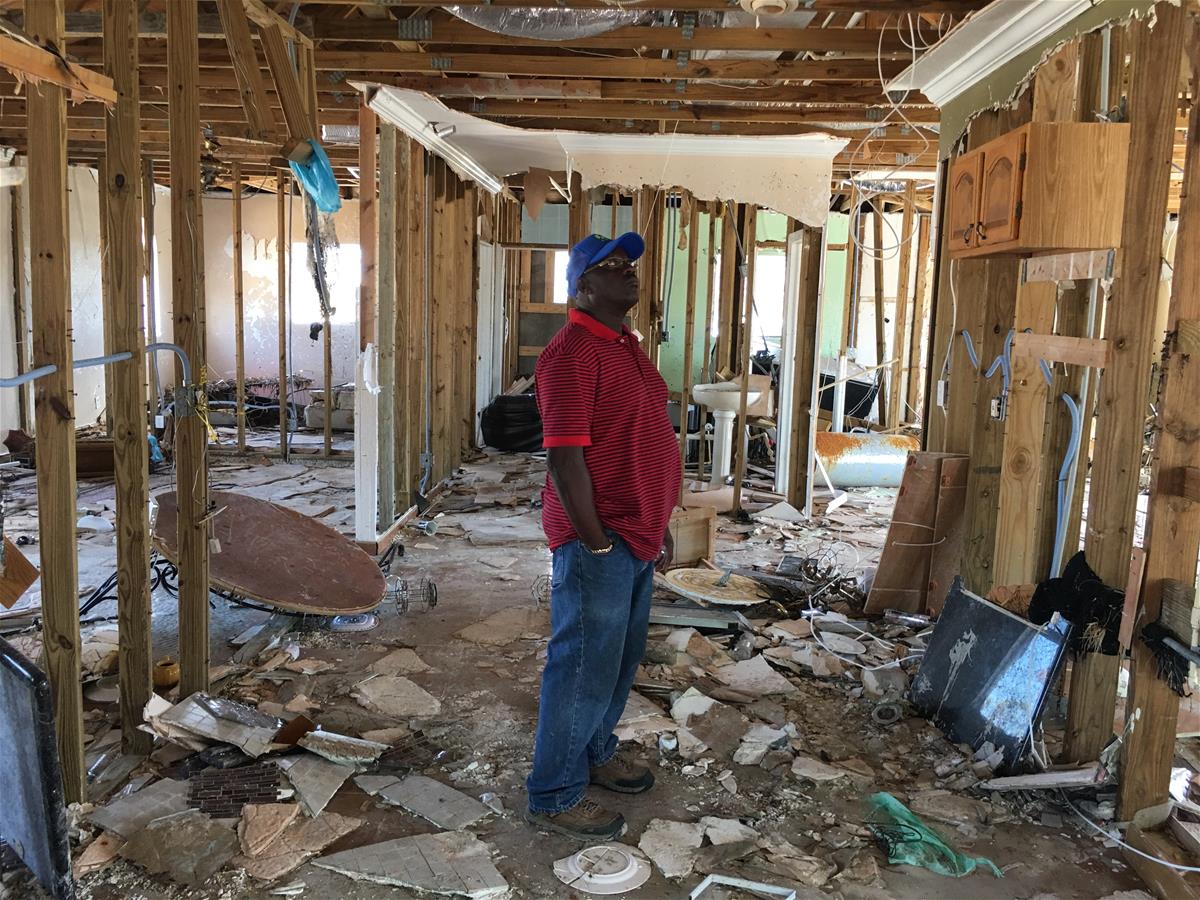 Pastor Simeon Outten in his storm-gutted house.