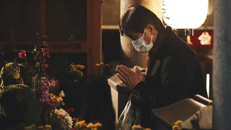 Man praying in Osaka