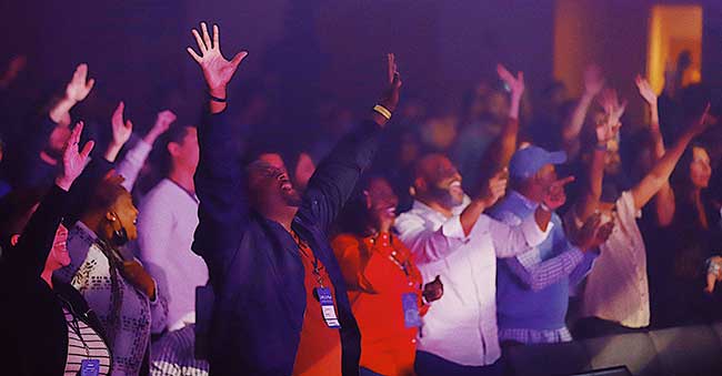 People worshipping at Unleash Conference