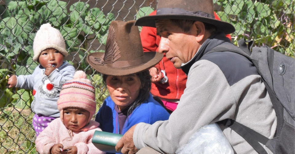 People sitting looking at Bible.